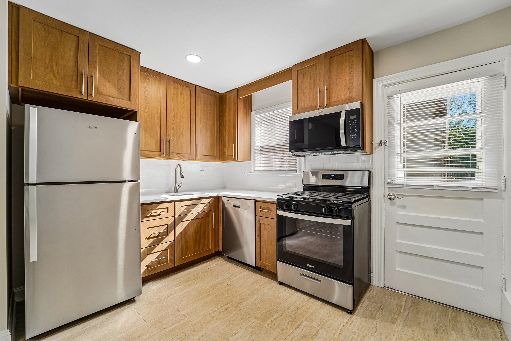 A kitchen with wooden cabinets and stainless steel appliances.